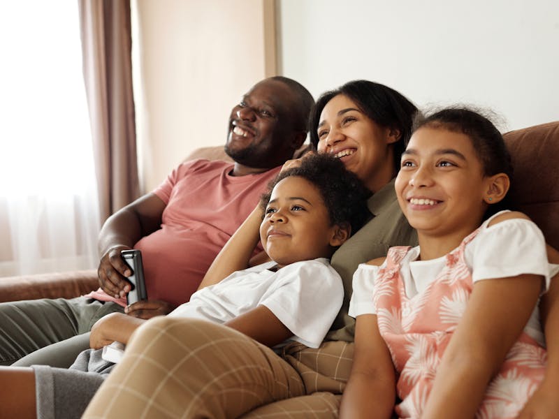 Happy family relaxing comfortably in living room with clean air