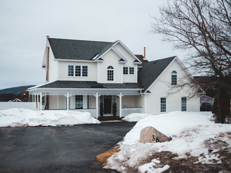 Suburban home in winter with snow showing need for reliable heating