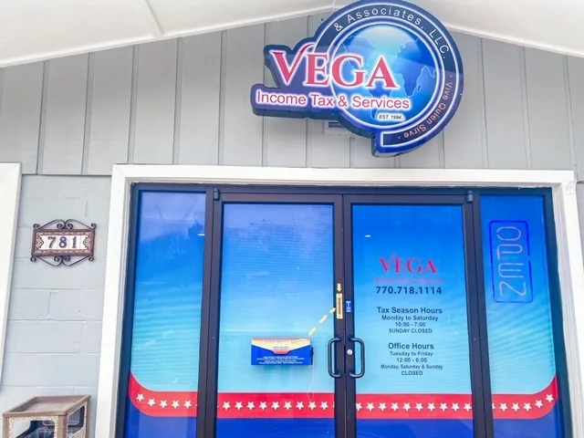 The Vega Income Tax entrance at 781 Hospital Drive, with the round Vega sign above blue glass doors
